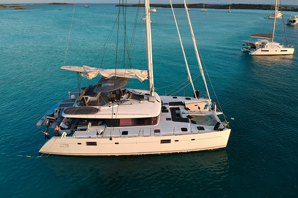 Spacious catamaran anchored near a secluded beach in Nassau.